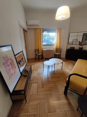 a living room with a couch and a table at Pagkrati Apartment 80 in Athens