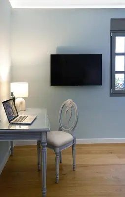 a desk with a laptop and a chair in a room at En Plaka - Athens Elegant Estate in Athens