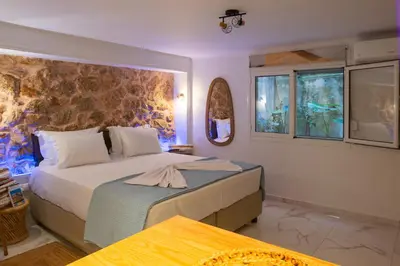 a bedroom with a large bed with a wall at just for two in Athens in Athens
