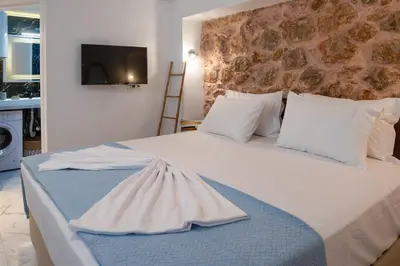 a bedroom with a large white bed with white pillows at just for two in Athens in Athens