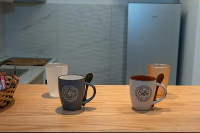 three coffee cups sitting on a table in a kitchen at just for two in Athens in Athens