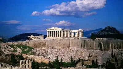 a building on top of a hill with trees in front at ALEX house in Athens