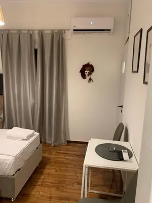 a room with a bed and a desk with a keyboard at ALEX house in Athens