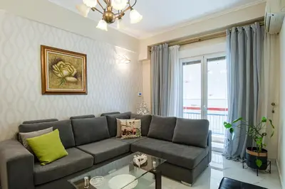 a living room with a couch and a window at Athens Hidden Gem Smyrnis in Athens