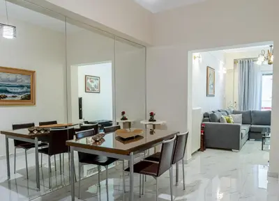 a living room with a table and chairs and a couch at Athens Hidden Gem Smyrnis in Athens