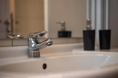 a bathroom sink with a chrome bathroom faucet at Athens Hidden Gem Smyrnis in Athens