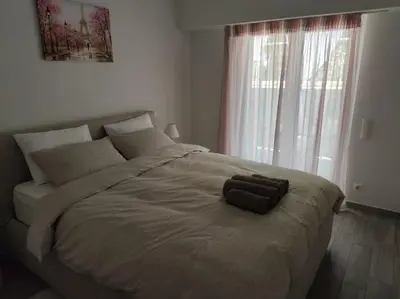a bedroom with a large bed with two towels on it at Welcome to Voula in Athens
