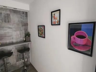 a painting of a pink hat on a wall at Welcome to Voula in Athens