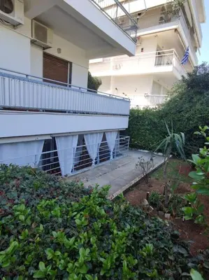 an apartment building with a balcony and a walkway at Welcome to Voula in Athens