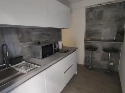 a kitchen with a counter top with a microwave at Welcome to Voula in Athens