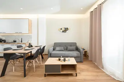 a living room with a couch and a table at Vitsas House By Greece Apartments in Athens