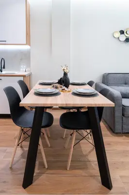 a wooden table with black chairs and a dining room at Vitsas House By Greece Apartments in Athens