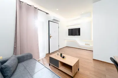 a living room with a couch and a coffee table at Vitsas House By Greece Apartments in Athens
