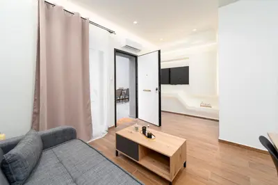a living room with a couch and a coffee table at Vitsas House By Greece Apartments in Athens