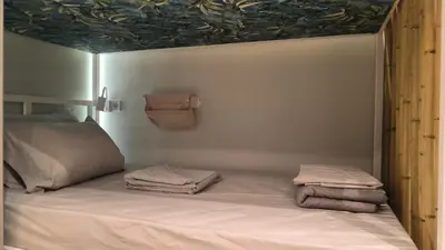 a bedroom with a bed with towels on it at EstelZan Studio in Athens
