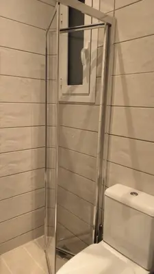 a bathroom with a glass shower with a toilet at EstelZan Studio in Athens