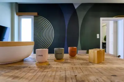 three coffee cups sitting on a wooden table at Voguish Design 2 bedroom Den in Athens