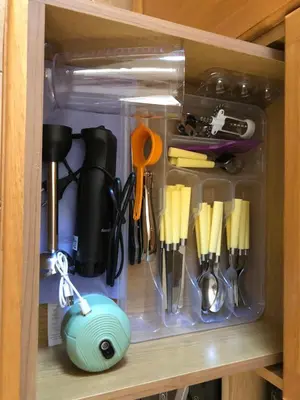 a drawer filled with kitchen utensils in a cabinet at Seaview penthouse by the beach in Kalívia Thorikoú
