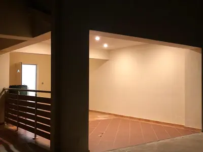 a room with a white wall and a staircase at Seaview penthouse by the beach in Kalívia Thorikoú
