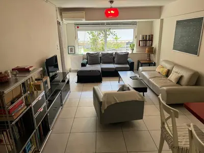 a living room with a couch and a tv at Georgia's house in Athens