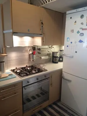 a kitchen with a stove and a white refrigerator at Georgia's house in Athens