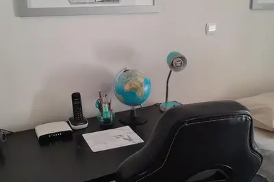 a desk with a chair and a globe on it at Georgia's house in Athens