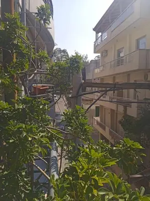 an alley between two buildings with trees at Georgia's house in Athens