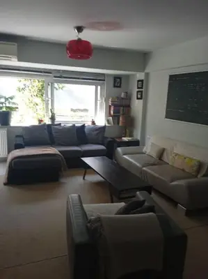 a large living room with couches and a table at Georgia's house in Athens