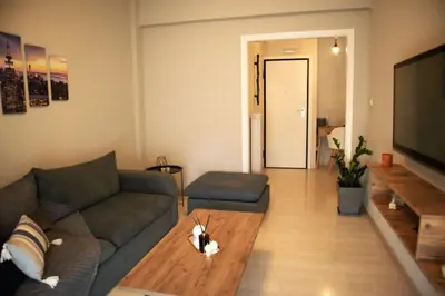 a living room with a couch and a coffee table at Mary's Apartment, Athens Zografou in Athens