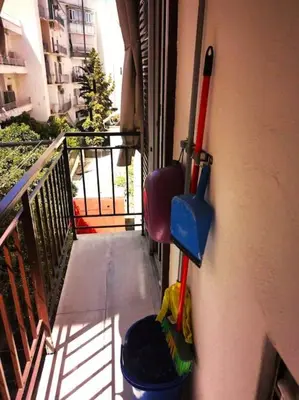 a balcony with some cleaning equipment on the side of a building at Mary's Apartment, Athens Zografou in Athens