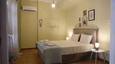 a bedroom with a bed and a table with towels on it at Classic Athenian house 2mins from metro in Athens