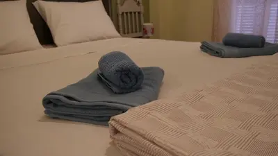 two towels sitting on top of a bed at Classic Athenian house 2mins from metro in Athens
