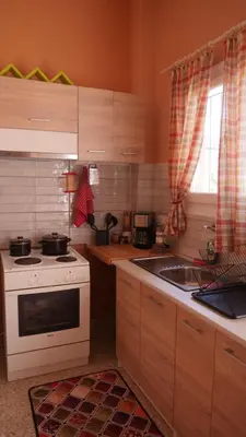 a kitchen with a white stove and a sink at Classic Athenian house 2mins from metro in Athens