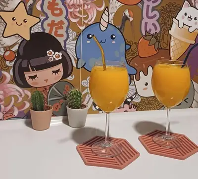 two glasses of orange juice on a table with plants at quiet apartment near the sea in Athens