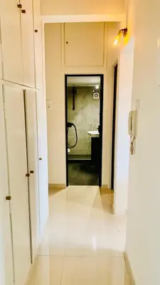 a hallway with a door to a bathroom with a shower at Kostas Athens Residence in Athens