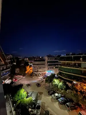 a view of a parking lot in a city at night at Kostas Athens Residence in Athens