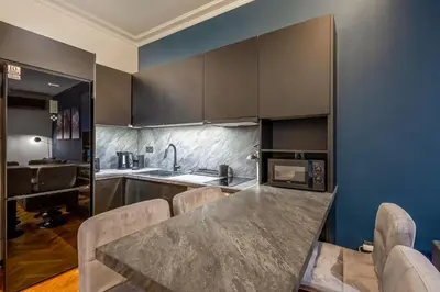 a kitchen with a large marble table and chairs at City Vibes Kolonaki in Athens
