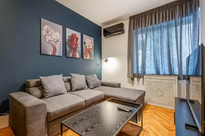 a living room with a couch and a table at City Vibes Kolonaki in Athens