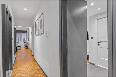 a hallway with white walls and a wooden floor at City Vibes Kolonaki in Athens