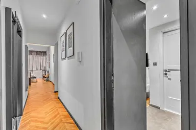 a hallway with white walls and a hard wood floor at City Vibes Kolonaki in Athens