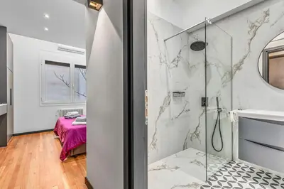 a bathroom with a walk in shower next to a sink at City Vibes Kolonaki in Athens