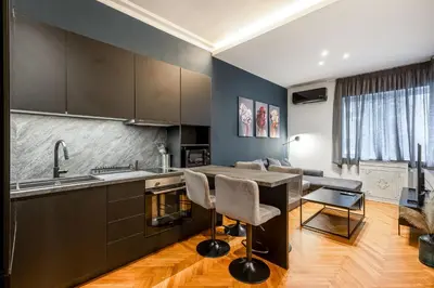 a kitchen with a table and chairs and a couch at City Vibes Kolonaki in Athens