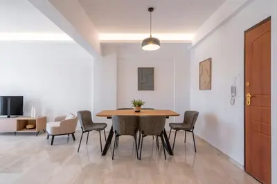 a dining room with a table and chairs at Athens Riviera 2BR Luxury Apartment in Athens