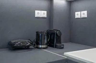 a kitchen counter with a coffee maker and a toaster at Athens Riviera 2BR Luxury Apartment in Athens