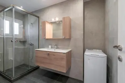 a bathroom with a sink and a shower and a toilet at Athens Riviera 2BR Luxury Apartment in Athens