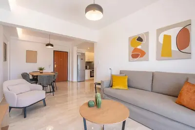a living room with a couch and a table at Athens Riviera 2BR Luxury Apartment in Athens