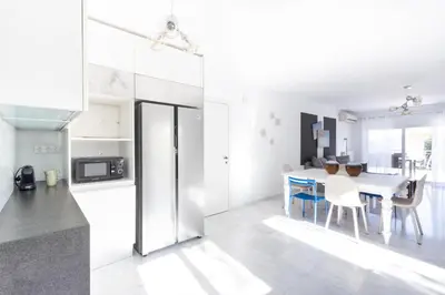 a kitchen and dining room with a table and chairs at Elegant Coastal Haven Fully Renovated 3-Bedroom Apartment in Athens