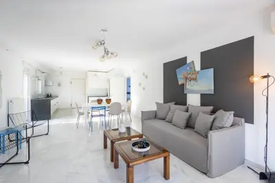 a living room with a couch and a table at Elegant Coastal Haven Fully Renovated 3-Bedroom Apartment in Athens
