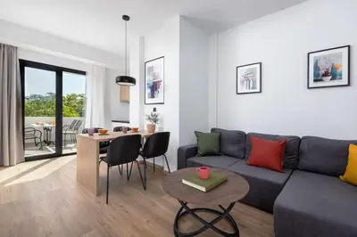 a living room with a couch and a table at The Meta Stay -Rooftop Access Sunny 2bdr Apartment in Athens