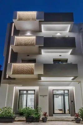 a facade of a building with potted plants at The Meta Stay -Rooftop Access Sunny 2bdr Apartment in Athens